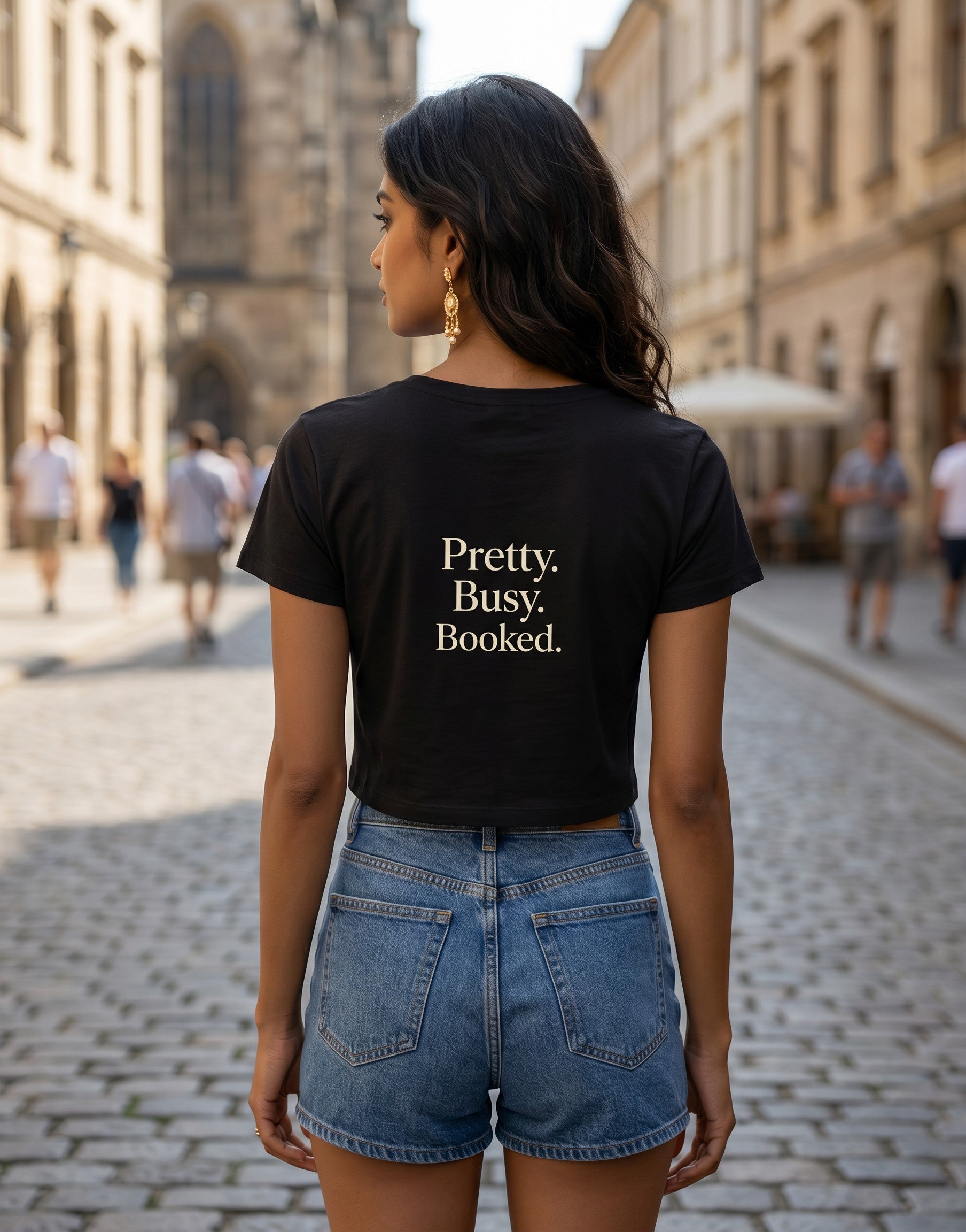 Fourthwave black cropped baby tee with "Pretty. Busy. Booked." text, made of 95% cotton and 5% spandex.