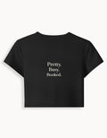Fourthwave black cropped baby tee with "Pretty. Busy. Booked." text, made from 95% cotton and 5% spandex blend.