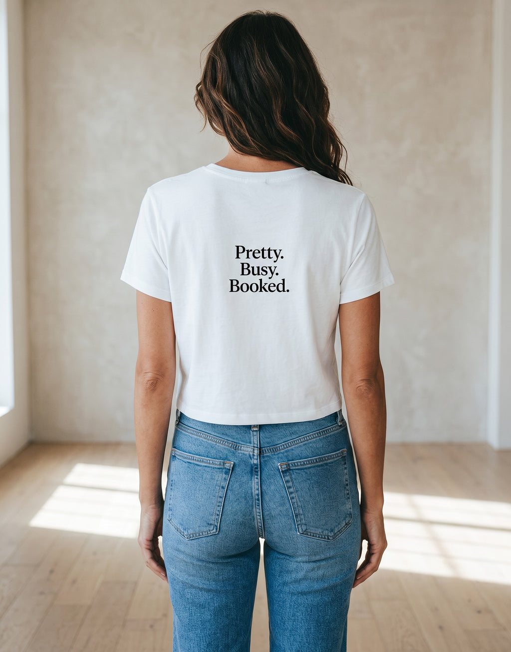 Fourthwave white cropped baby tee with black text that reads "Pretty. Busy. Booked."