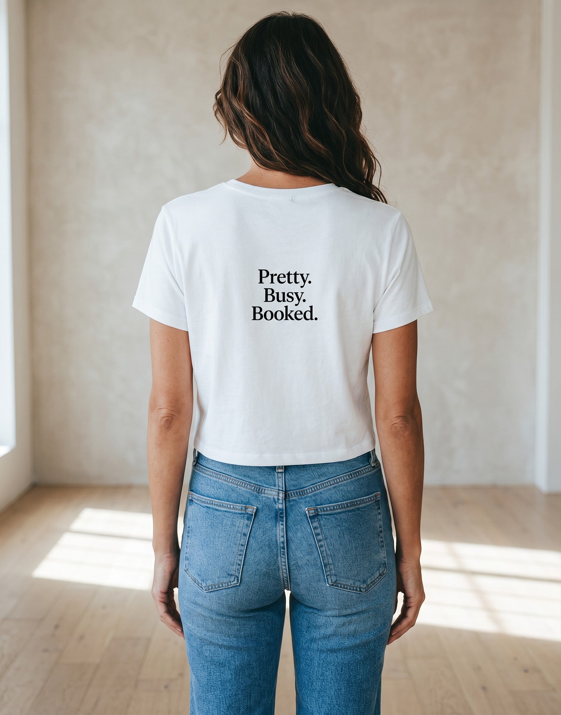 Fourthwave white cropped baby tee with black text that reads "Pretty. Busy. Booked."