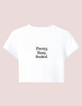 Fourthwave white cropped baby tee with black text that reads "Pretty. Busy. Booked."